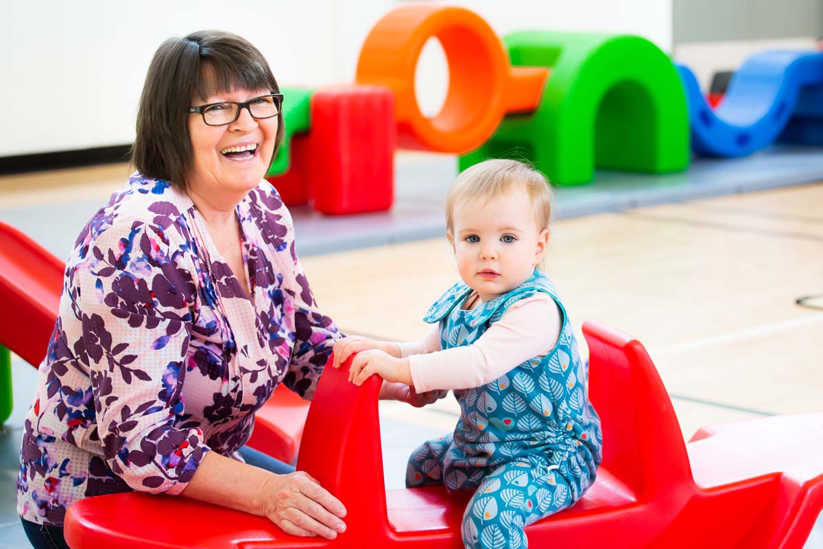 Mature woman taking care of a toddler